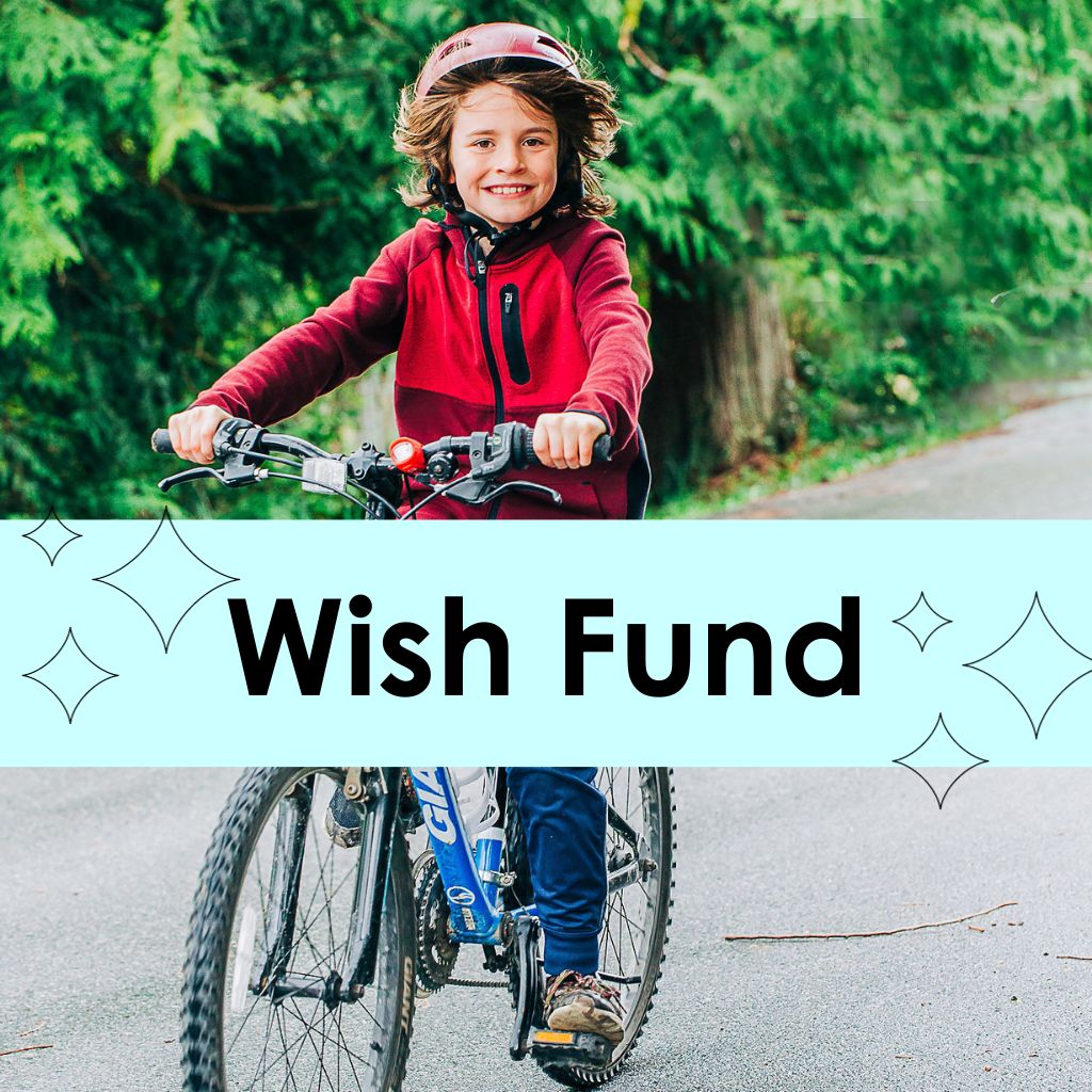 A young boy riding a bike with the words, Wish Fund overlayed on the image