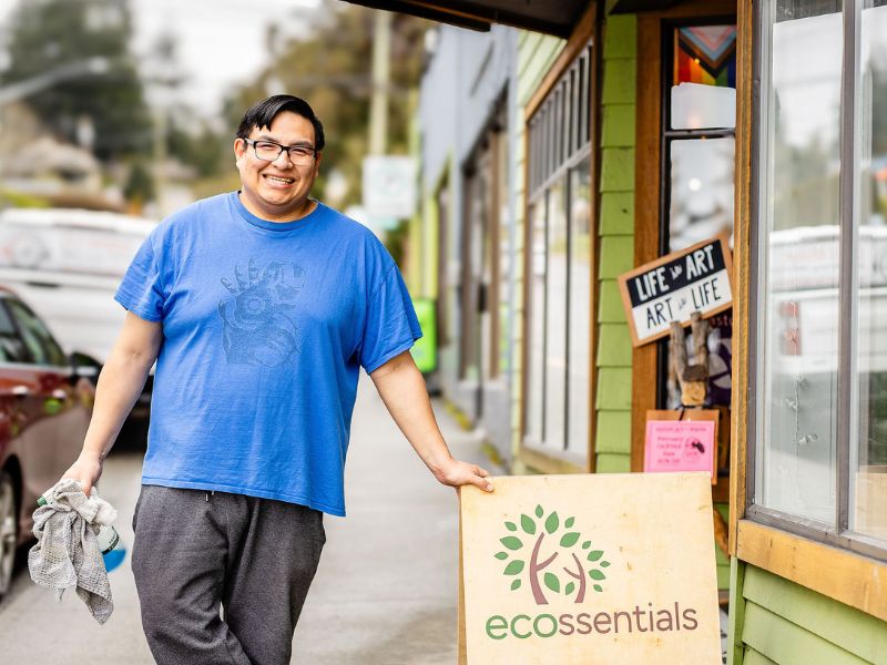 An individual with an intellectual disability standing outside his place of employment - inclusion powell river