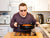 Individual with an intellectual disability cooking in his kitchen - inclusion powell river